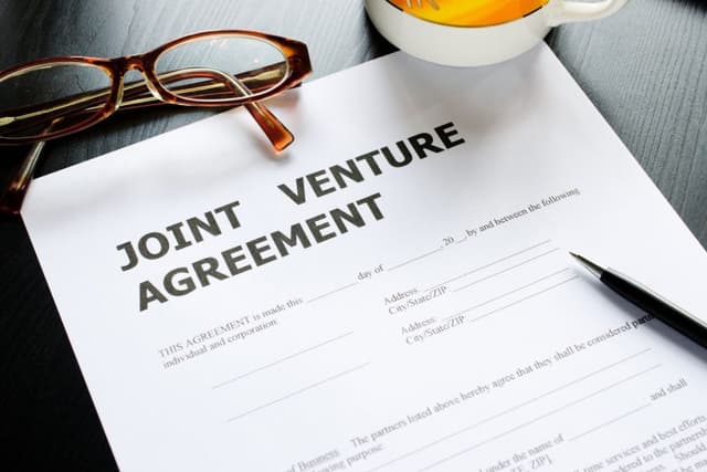How is a partnership similar to a joint venture?